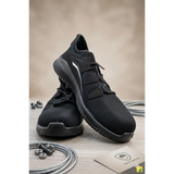 Men’s black lightweight safety work sneakers with mesh upper, reinforced toe cap, and white accent stripe